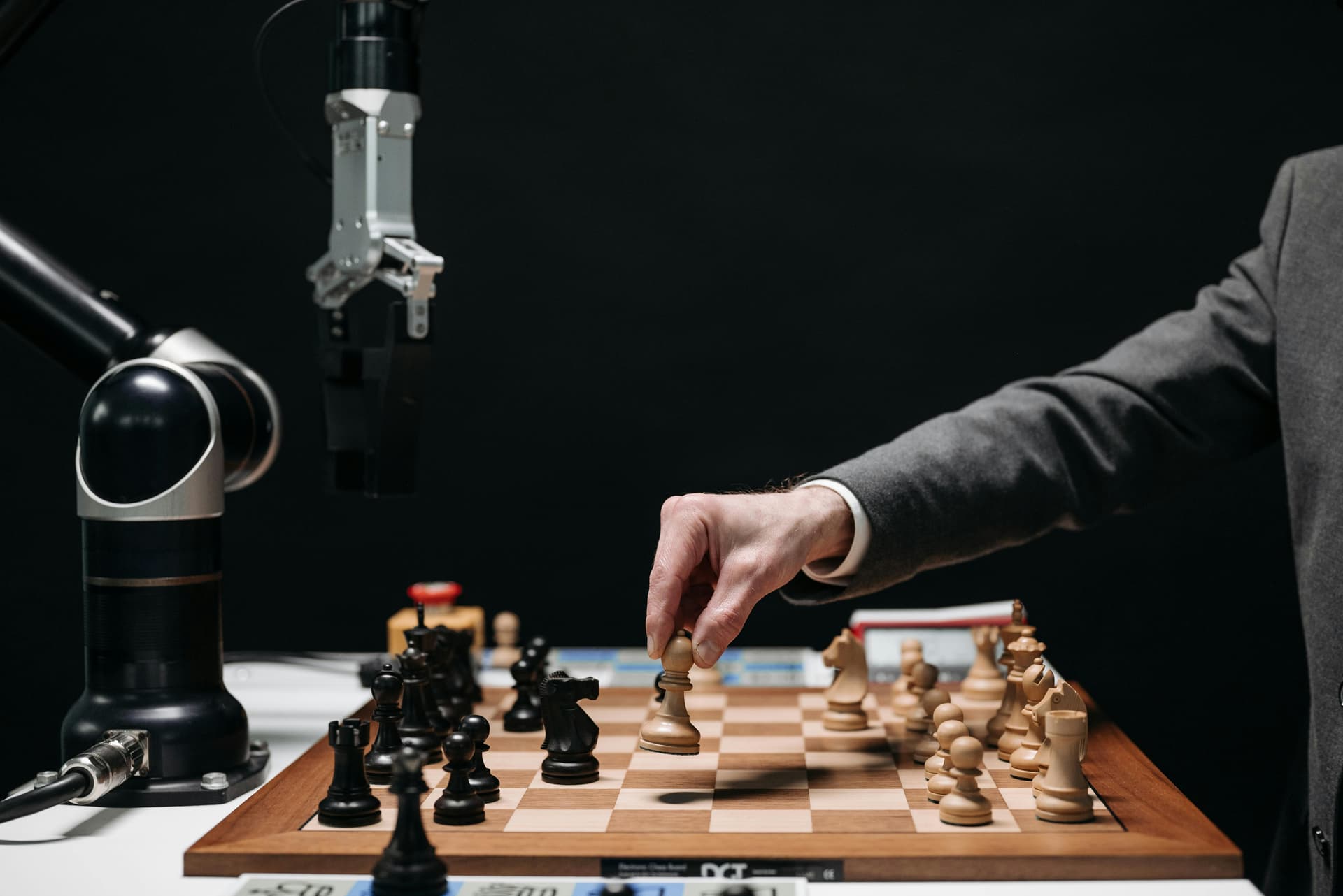 Human playing chess with a robot.
