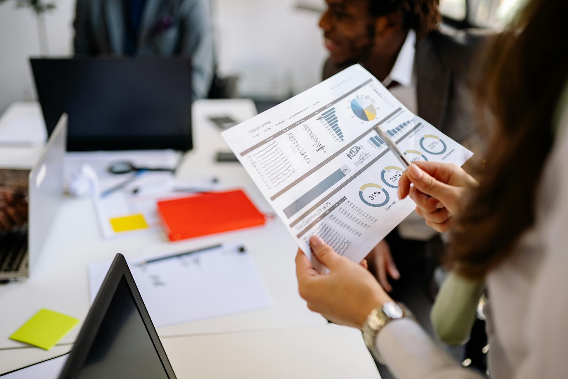 Woman looking at data in charts on paper.